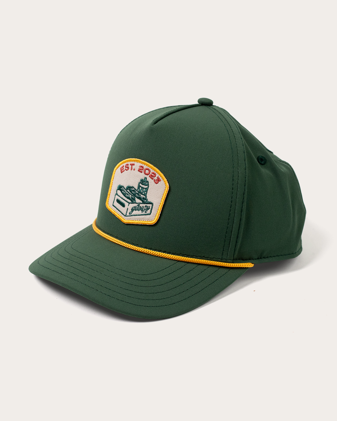 Green performance snapback hat with a cream patch showing the Gleezy hot dog box logo and 'Est. 2023'
