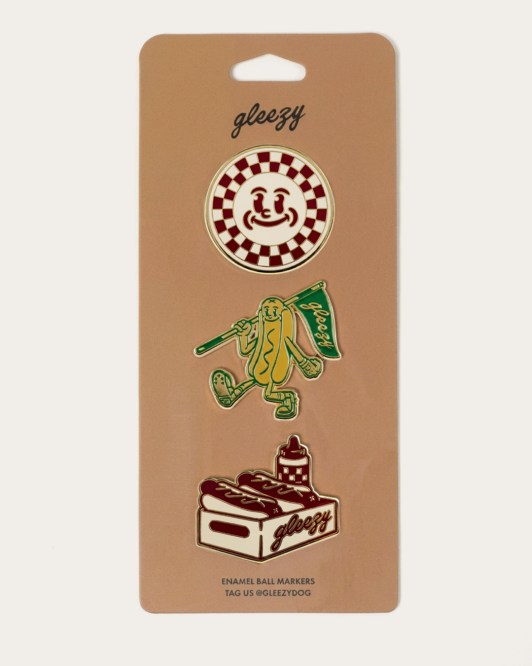 Gleezy enamel ball markers packaging with illustrations on a beige background