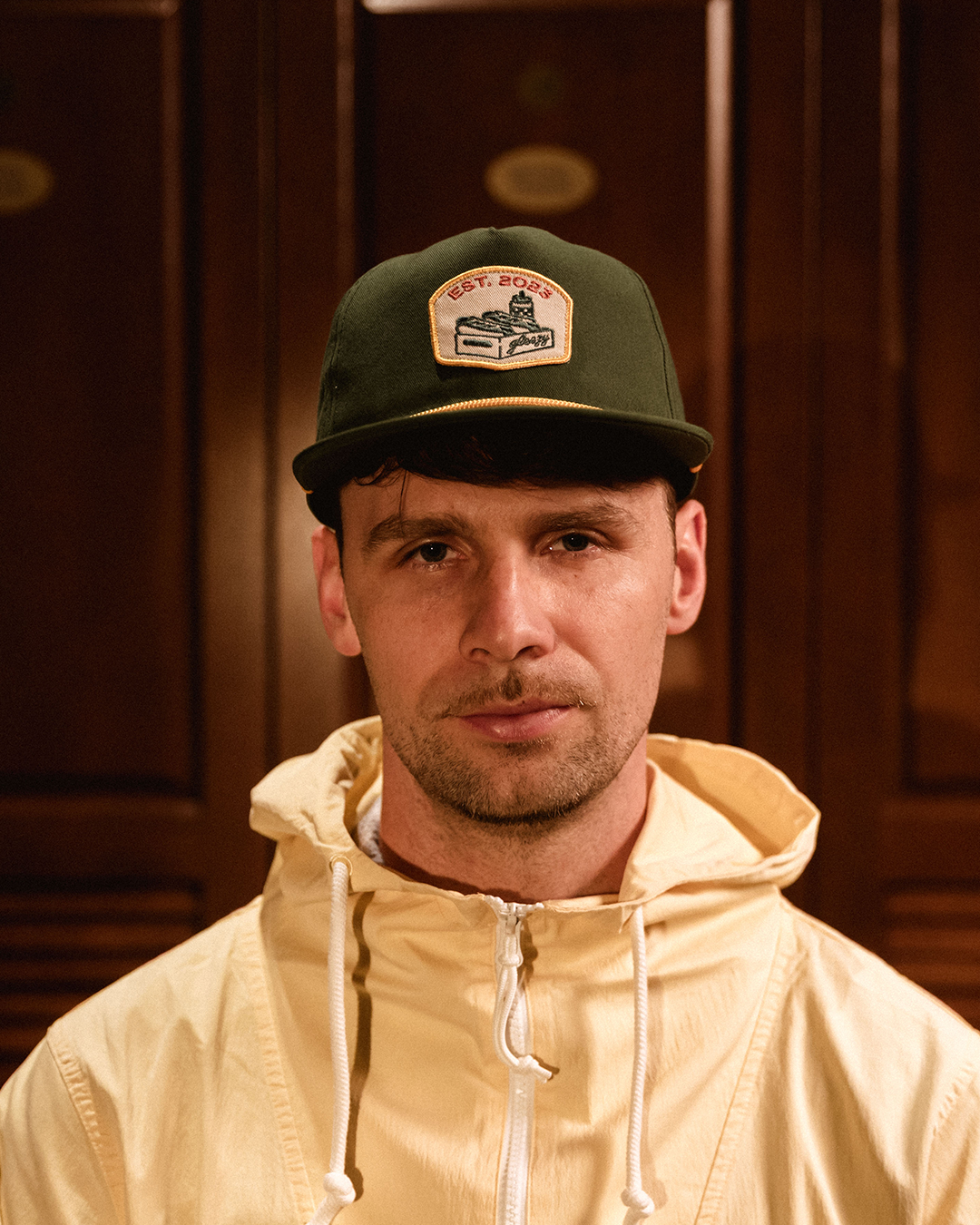 Man wearing the green Gleezy rope snapback hat with the hot dog box patch